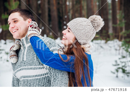 Loving young couple having fun in winter forest . Loving young couple having fun in winter forest . 47671918