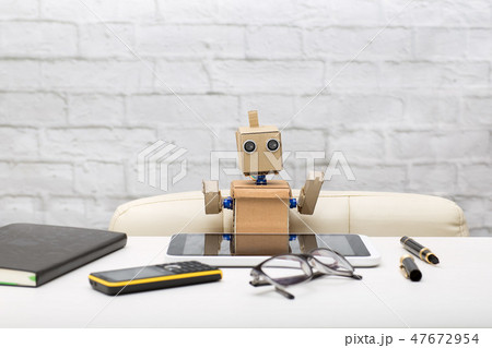 robot is sitting at the table robot is sitting at the table 47672954