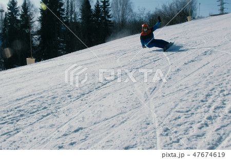 Man slides on a snowboard and ski from snow descent. 47674619