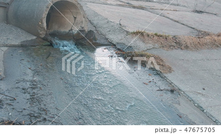 Dirty water flows from the pipe. Environmental pollution. Sewage, treatment facilities, side view. Dirty water flows from the pipe. Environmental pollution. Sewage, treatment facilities, side view. 47675705