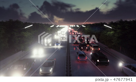 The camera flies over heavy traffic. Cars with lights on go through the city at night. 3D Rendering 47677941