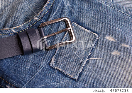 Belt lying on blue jeans. Belt lying on blue jeans. 47678258