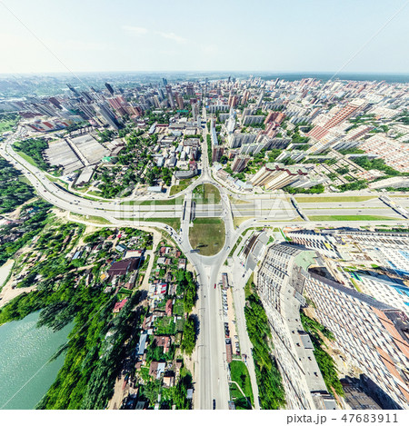 Aerial city view with crossroads and roads, houses, buildings, parks and parking lots. Sunny summer Aerial city view with crossroads and roads, houses, buildings, parks and parking lots. Sunny summer 47683911