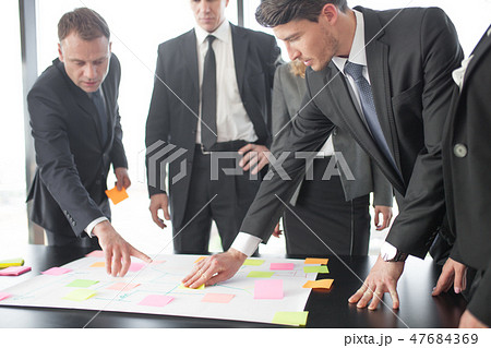 Business people developing plan on office desk 47684369