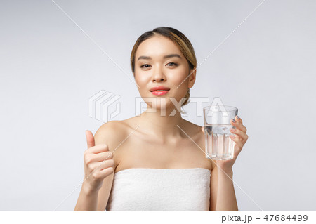 relaxed young smiling woman drinking clean water. 47684499