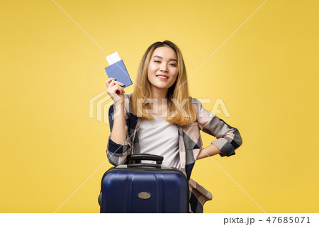 Woman travel. Young beautiful asian woman traveler holding passport ,suitcase and air ticket Woman travel. Young beautiful asian woman traveler holding passport ,suitcase and air ticket 47685071