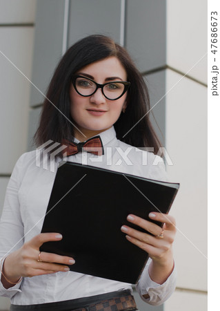 Modern business, woman near the office ponders 47686673