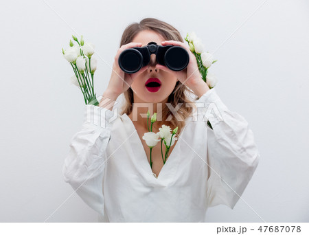Beautiful woman with white roses in sleeves with binocular Beautiful woman with white roses in sleeves with binocular 47687078