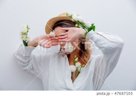 Beautiful woman with white roses in sleeves  47687103