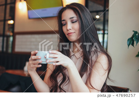 Beautiful Asian girl has Breakfast coffee at cafe 47690257