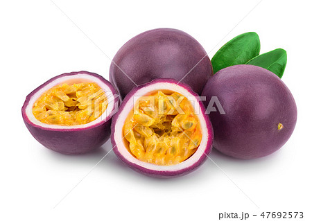 Two whole passion fruits and a half with leaves isolated on white background. Isolated maracuya Two whole passion fruits and a half with leaves isolated on white background. Isolated maracuya 47692573