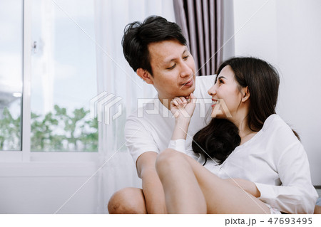 Asian couple in the bedroom on holiday morning. Asian couple in the bedroom on holiday morning. 47693495