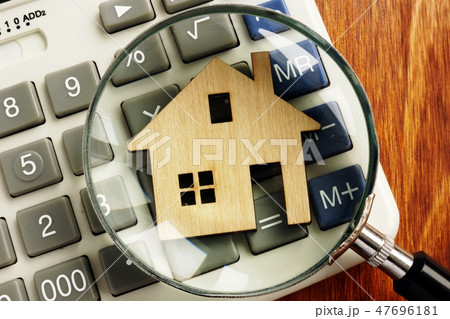 House value. Model of home and magnifying glass. House value. Model of home and magnifying glass. 47696181