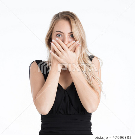 Beautiful woman covering mouth by her hands. 47696302