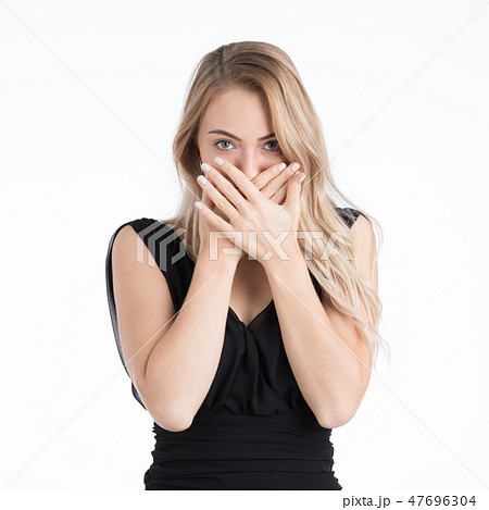 Beautiful woman covering mouth by her hands. 47696304