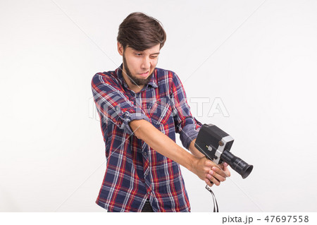 Funny people, photo and vintage concept - young man using vintage camera on white background Funny people, photo and vintage concept - young man using vintage camera on white background 47697558