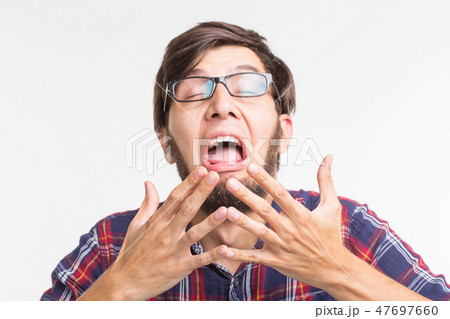 People, feelings and gesture concept - scared man hiding behind his hands from something unseen on 47697660