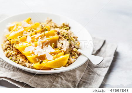 Oatmeal with mango, coconut, peanut butter 47697843