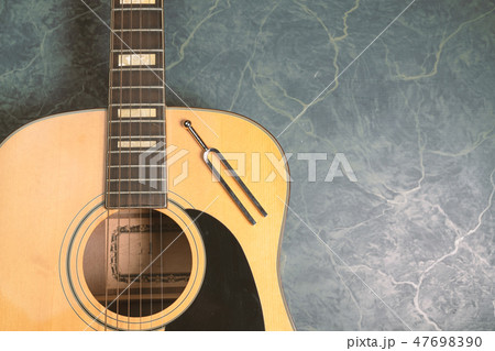 tuning fork and acoustic guitar 47698390