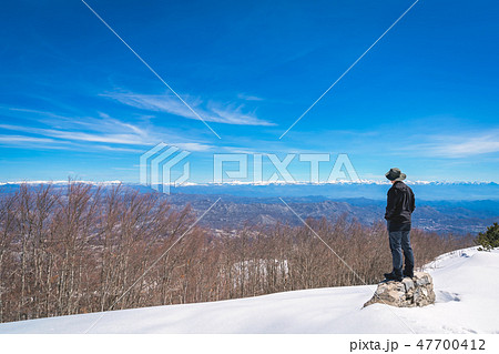 Man admiring the winter beauty of Lovcen NP 47700412