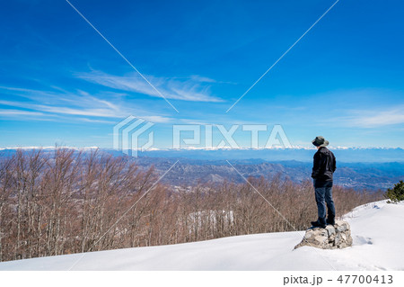 Man admiring the winter beauty of Lovcen NP 47700413