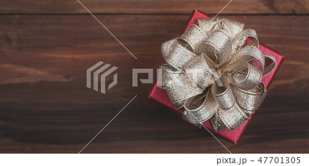 One classic red gift box golden bow on natural . One classic red gift box golden bow on natural . 47701305