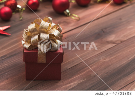 Close up view beautiful red gift with golden bow 47701308