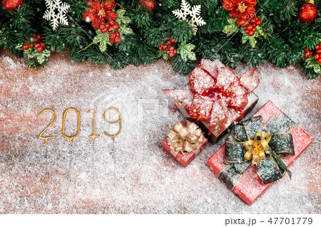Year 2019 gold color on wooden board and snowflake 47701779