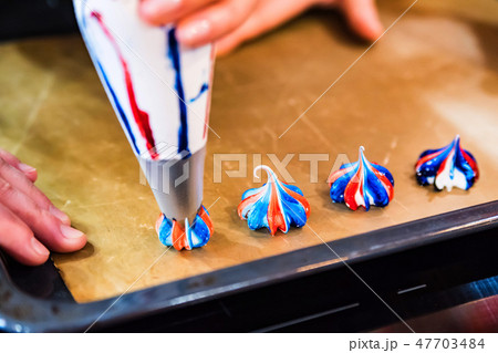 Making colorful meringues with pastry bag close up 47703484