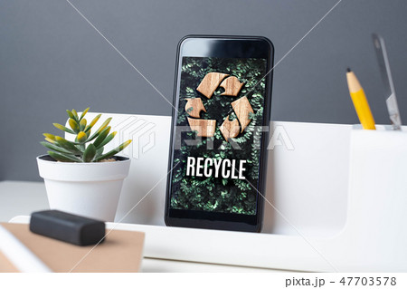 Recycle sign on green leaf on mobile app at office Recycle sign on green leaf on mobile app at office 47703578