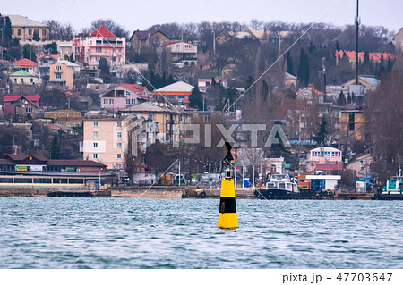 Close view of black and yellow beacon in Black sea Close view of black and yellow beacon in Black sea 47703647