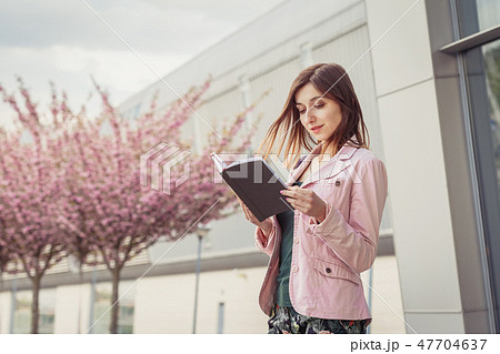 Woman portrait over pink blooming trees outside 47704637