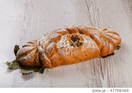 Freshly baked bread on a wooden background. Freshly baked bread on a wooden background. 47706360