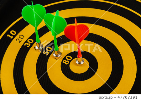 The game of darts, darts on the target. 47707391