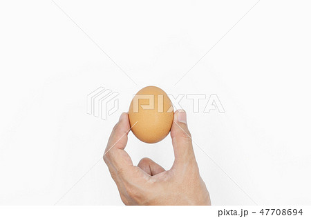 Hand holding egg, isolated on white background Hand holding egg, isolated on white background 47708694