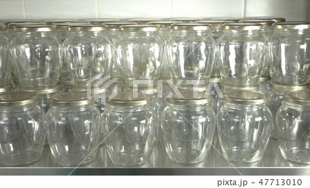Rows of many glass jars close up. Rows of many glass jars close up. 47713010