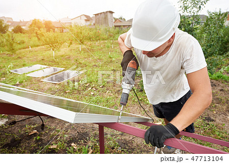 Installation of stand-alone exterior photo voltaic panels system. Renewable green energy generation. 47713104