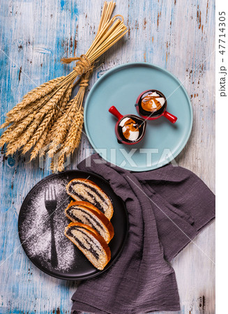 Poppy seed strudel on dark plate  47714305
