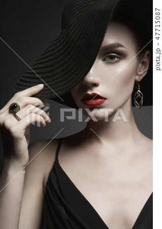 portrait of young lady with black hat and evening dress portrait of young lady with black hat and evening dress 47715087