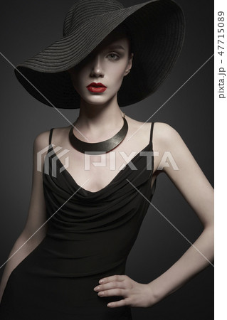 portrait of young lady with black hat and evening dress 47715089
