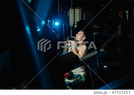 Handsome athletic man working out on the gym Handsome athletic man working out on the gym 47715255