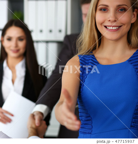 Woman in suit give hand as hello in office 47715937