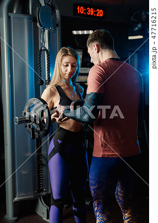 Handsome athletic man training biceps barbell in 47716215