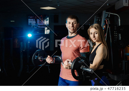 Handsome athletic man training biceps barbell in 47716235