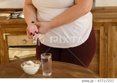 obese woman measuring pulse. unhealthy lifestyle obese woman measuring pulse. unhealthy lifestyle 47717257