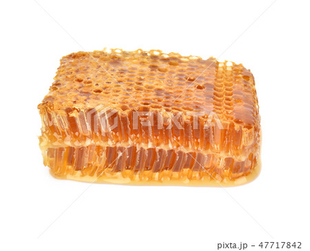 Yellow Honeycomb slice closeup on white background 47717842