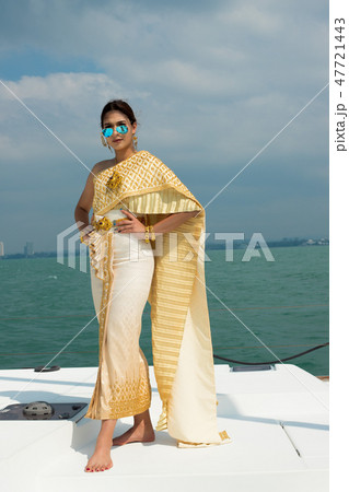 Asian Woman Gold Yellow Thai Traditional Costume Asian Woman Gold Yellow Thai Traditional Costume 47721443