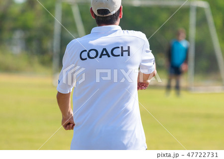 Back of football coach wearing white COACH shirt Back of football coach wearing white COACH shirt 47722731