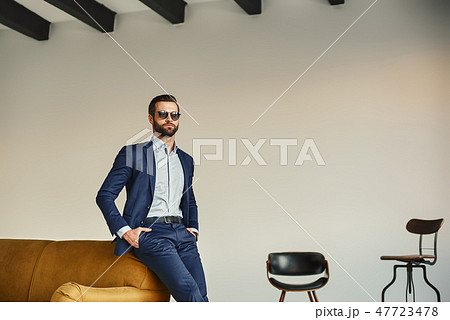 Success in everything... Elegant handsome businessman in stylish suit and dark sunglasses is 47723478