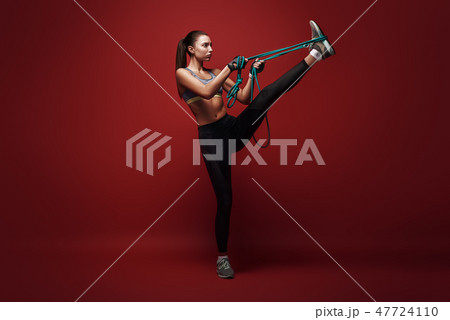 Once you can control your mind, you can control your body. Beautiful sportswoman performs exercises 47724110